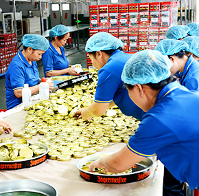 Nice-Can employees are packing the tin box